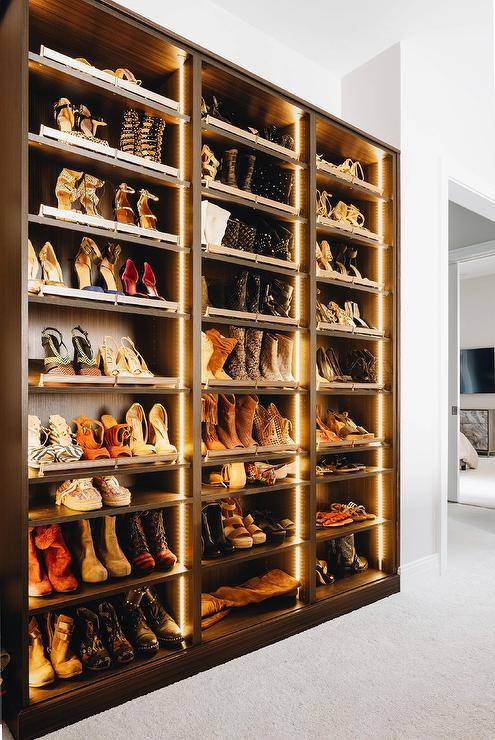 Contemporary brown shoe shelves feature custom lighting.