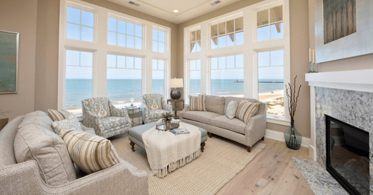 Modern living room of a Bungalow house, showcasing grey couches and a large firplace.