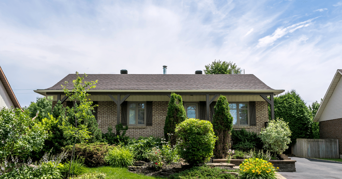 Bungalow house surrounded by trees.