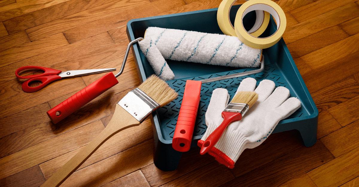 Assortment of painting tools on the floor.