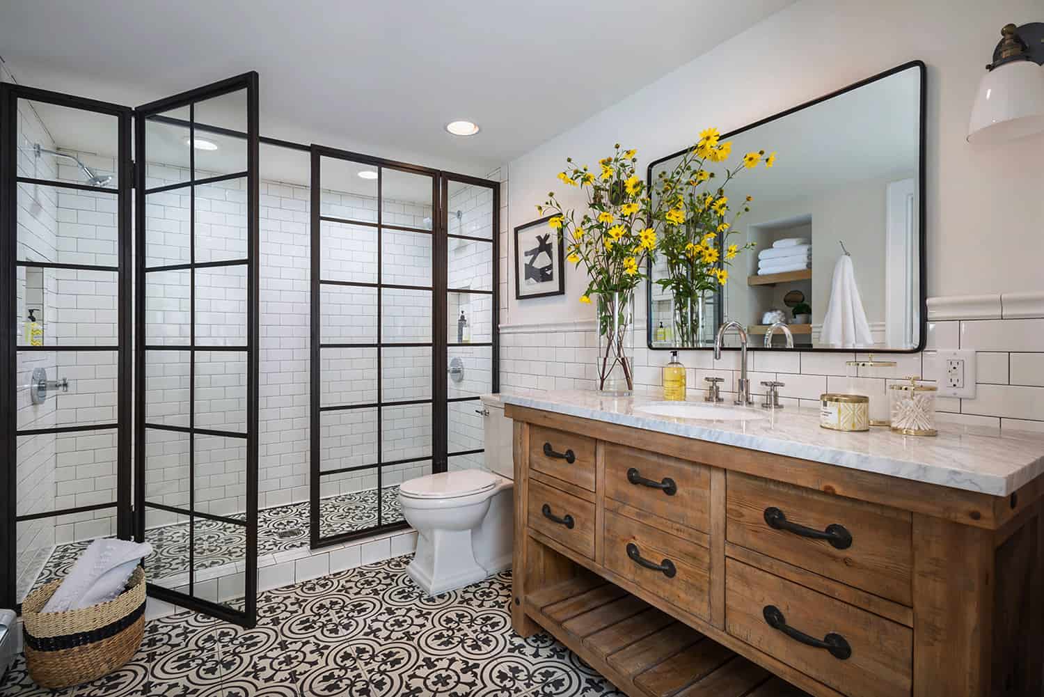 farmhouse bathroom with glass black frame doors wood vanity with subway tile black frame mirror