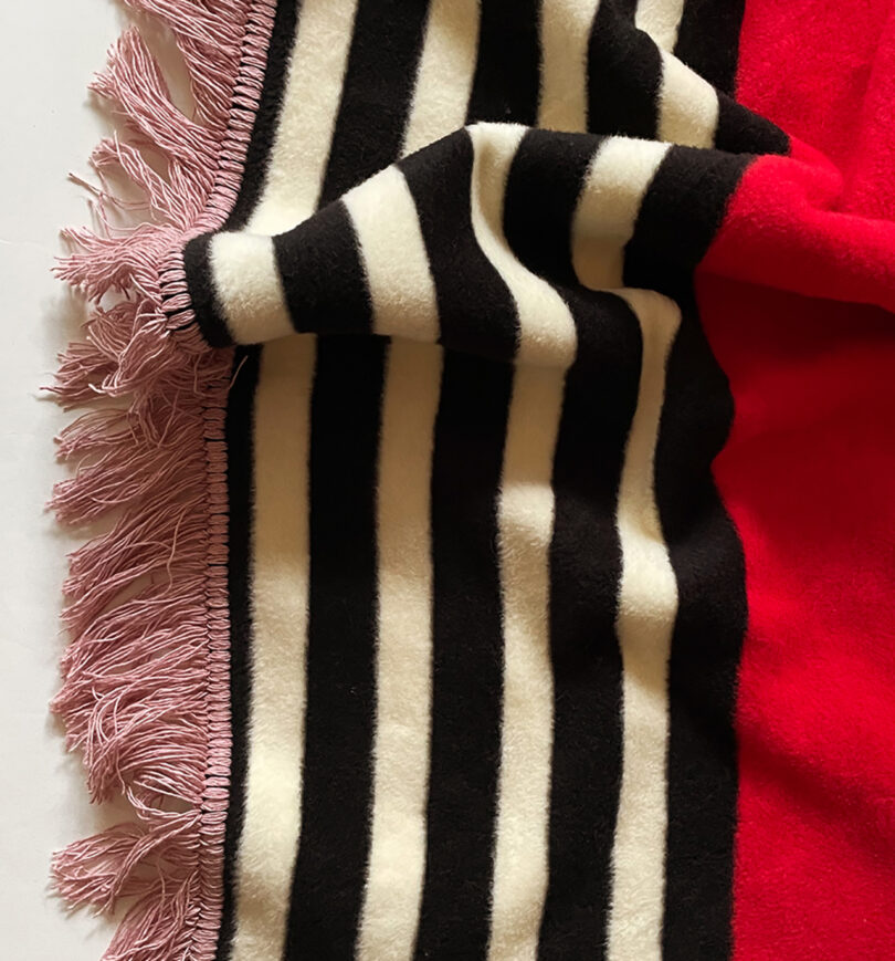 detail of pink, blue, red, white, and black geometric abstract throw blanket
