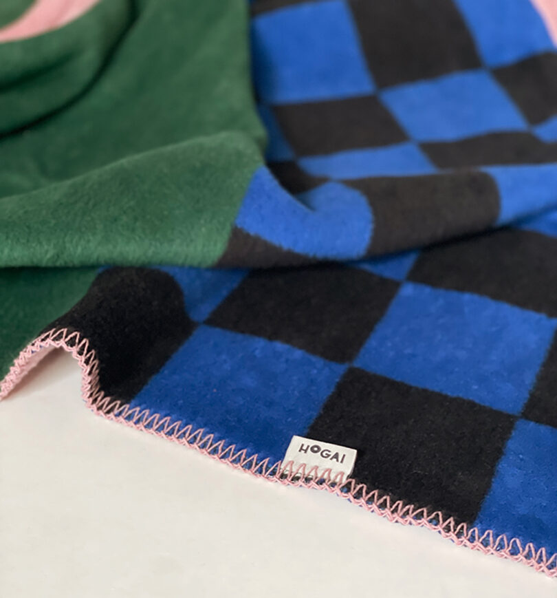 detail of pink, blue, green, and black geometric abstract throw blanket