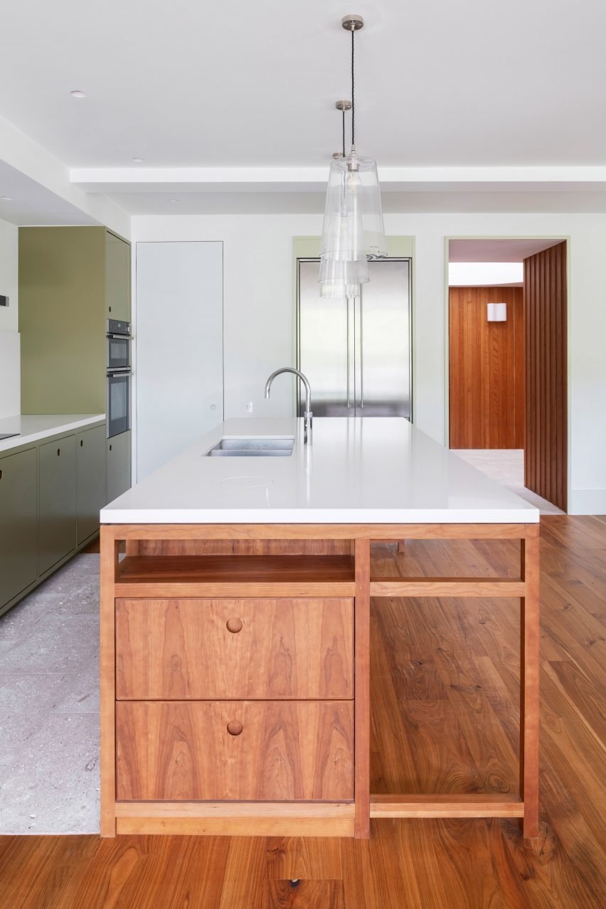 Kitchen island and green cabinets in Wimbledon Villa