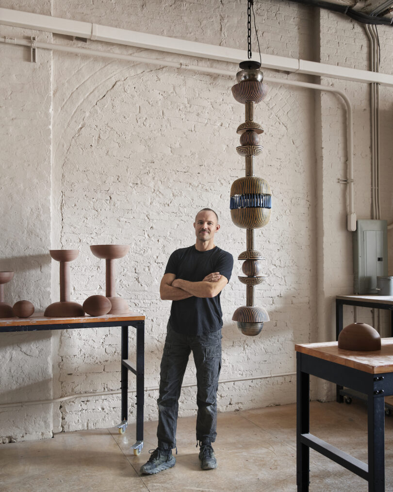 man standing next to pendant lamp