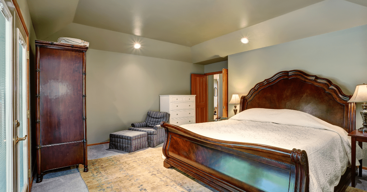 Rustic bedroom with a rug under the bed.