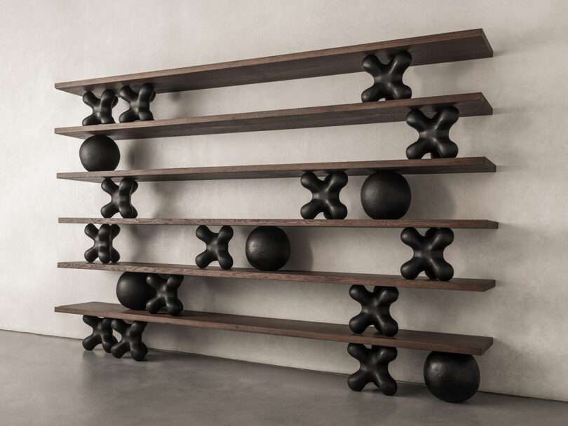 bookshelves separated by sculptural Xs and balls