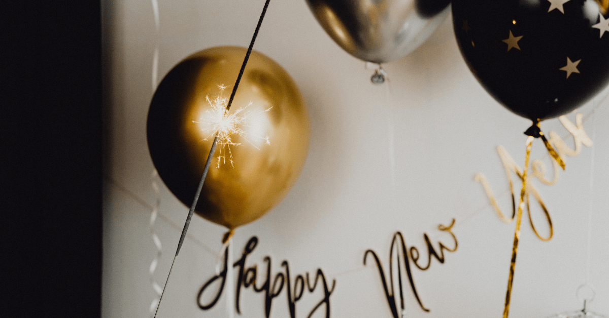 Black and silver balloons which also read Happy New Year.