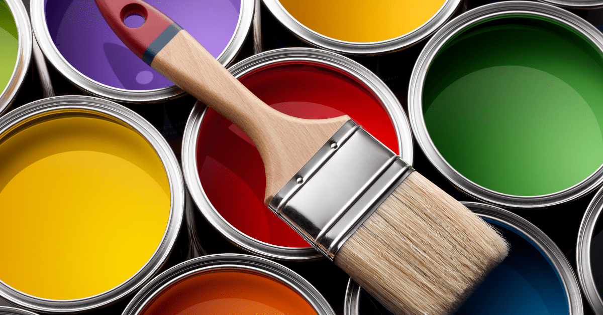 A brush on top of paint cans.