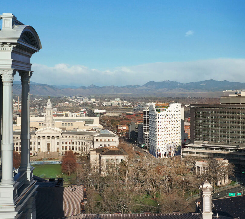 Render of the Populous hotel on site set against the Denver cityscape with the Rocky Mountains in the background.