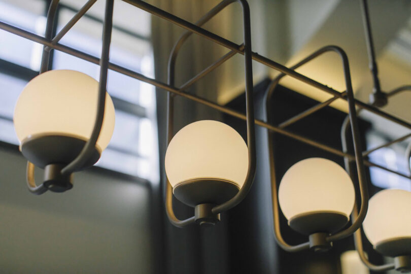 Architectural lighting detailing inside The Hotel Seiryu Kyoto Kiyomizu, of four modern hanging globe lights