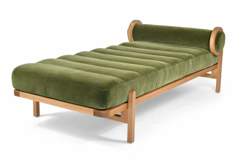 A minimal daybed with green upholstery.