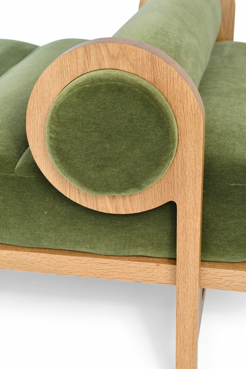 Detail of a minimal daybed with green upholstery.