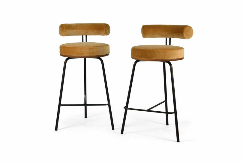 A pair of minimalist stools with upholstered seats and backs.