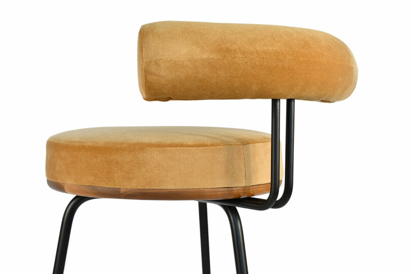 Detail of upholstered stool's seat and back.