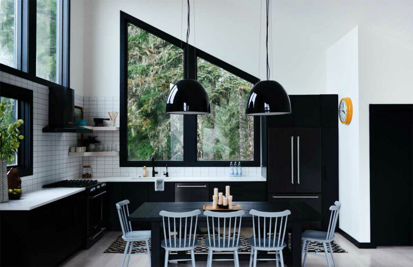 modern kitchen interior with black cabinets and appliance and an angled black framed window