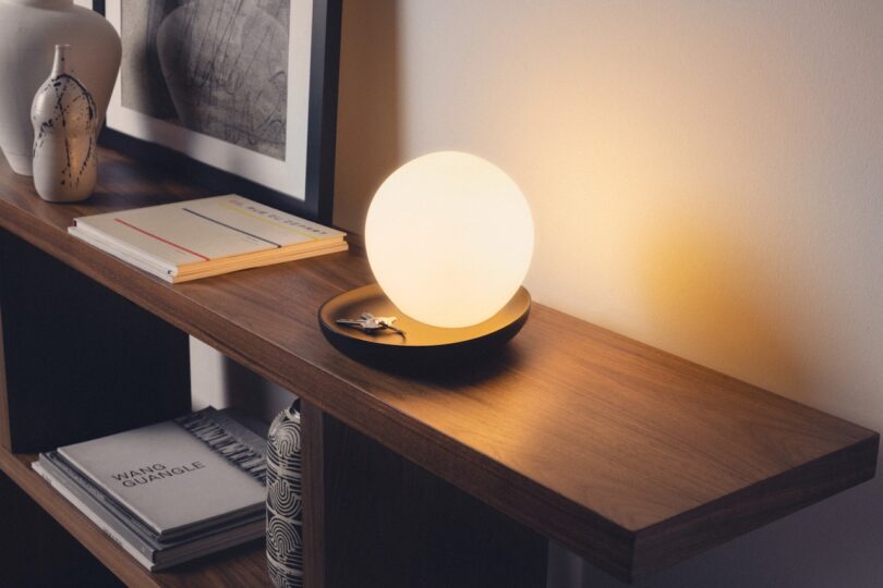 round lamp on wooden console