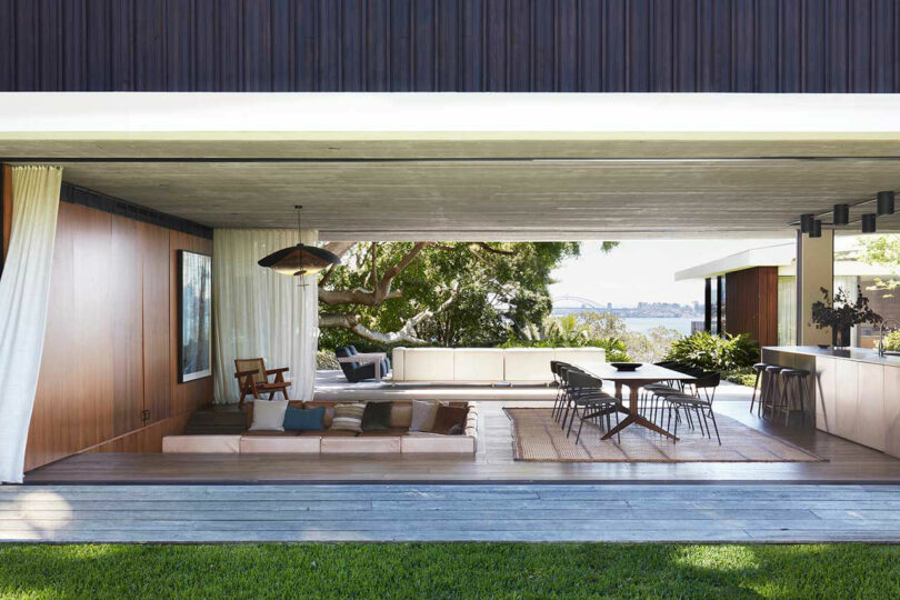 open covered breezeway living room and kitchen open to the surrounding yard