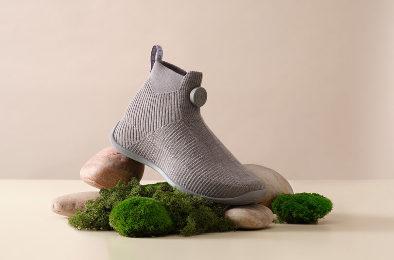 Allbirds' Moonshot merino wool sneaker set upon fake moss and stones.