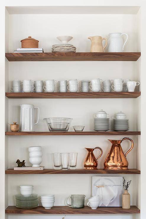 Kitchen alcove is fitted with styled walnut floating shelves.