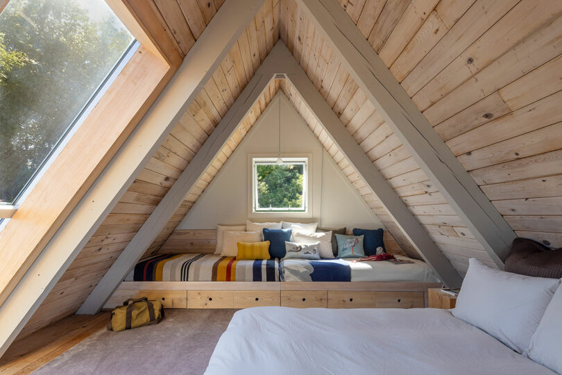 triangular top floor bedroom of modern a-frame cabin