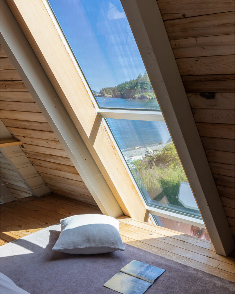 triangular top floor bedroom of modern a-frame cabin