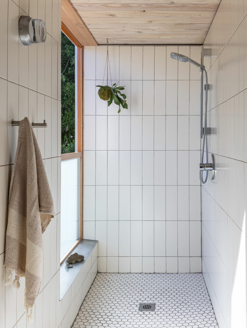 minimalist modern shower with large vertical rectangular white tiles