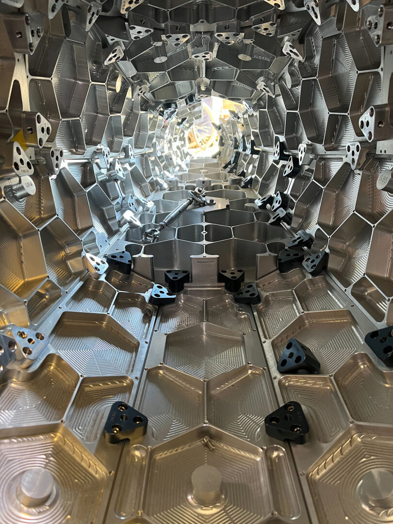 Photo of the interior of the large polished aluminum sculpture of the Concorde jet plane, revealing over 3,000 brackets and 8,000 bolts.