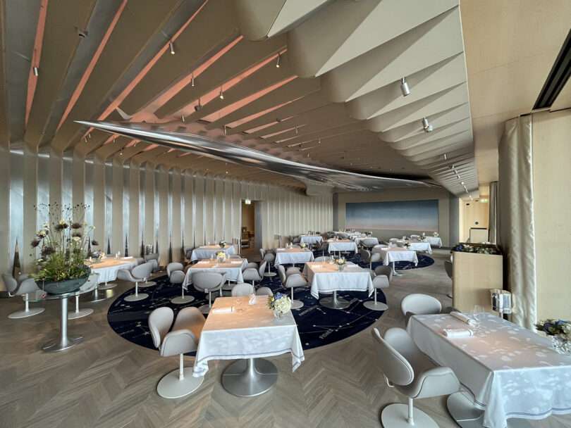 Dining room of the Brooklands restaurant with large polished aluminum sculpture of the Concorde jet plane secured above across the ceiling.