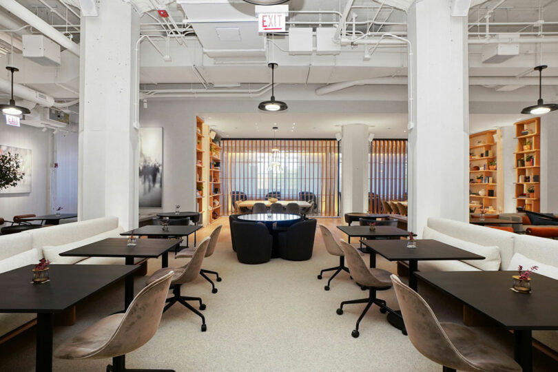Sprawling office space with lounge seating and work tables.