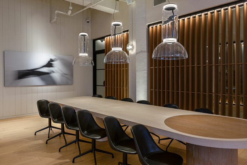 A long communal table under pendant lighting