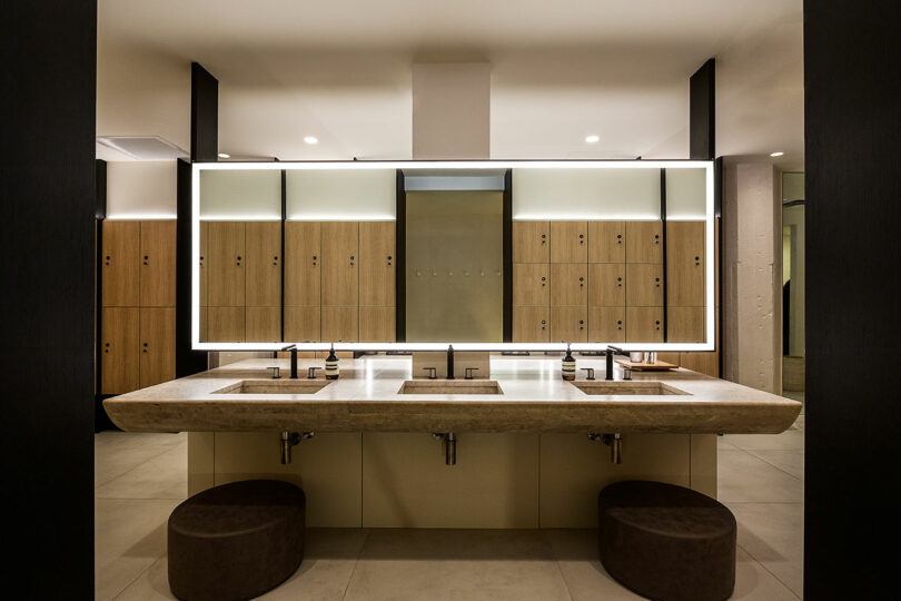 View into locker room sinks and mirror.