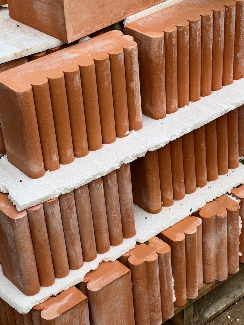 terracotta fluted bricks stacked on top of each other