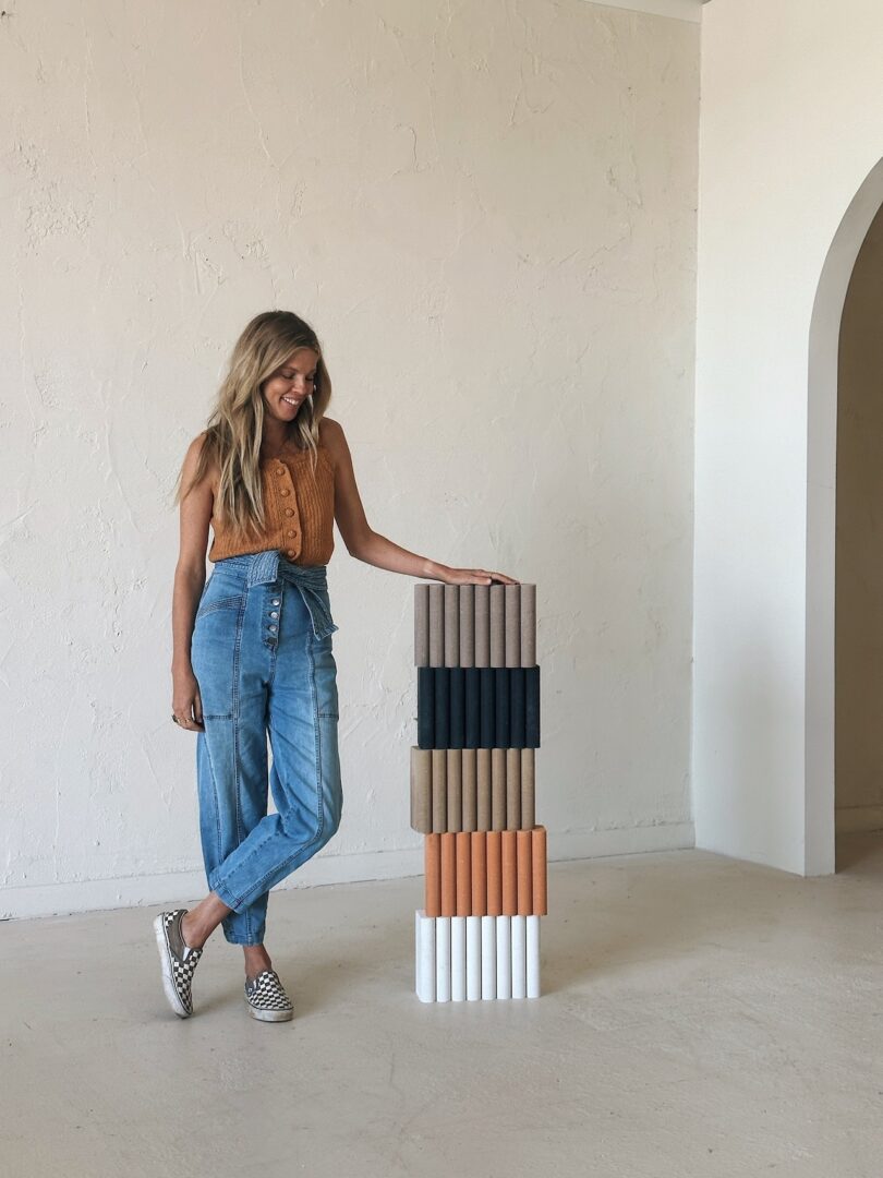 woman standing next to brick samples