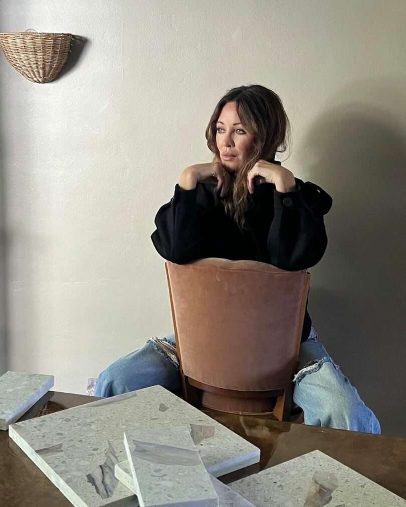 woman sitting in chair with tile samples