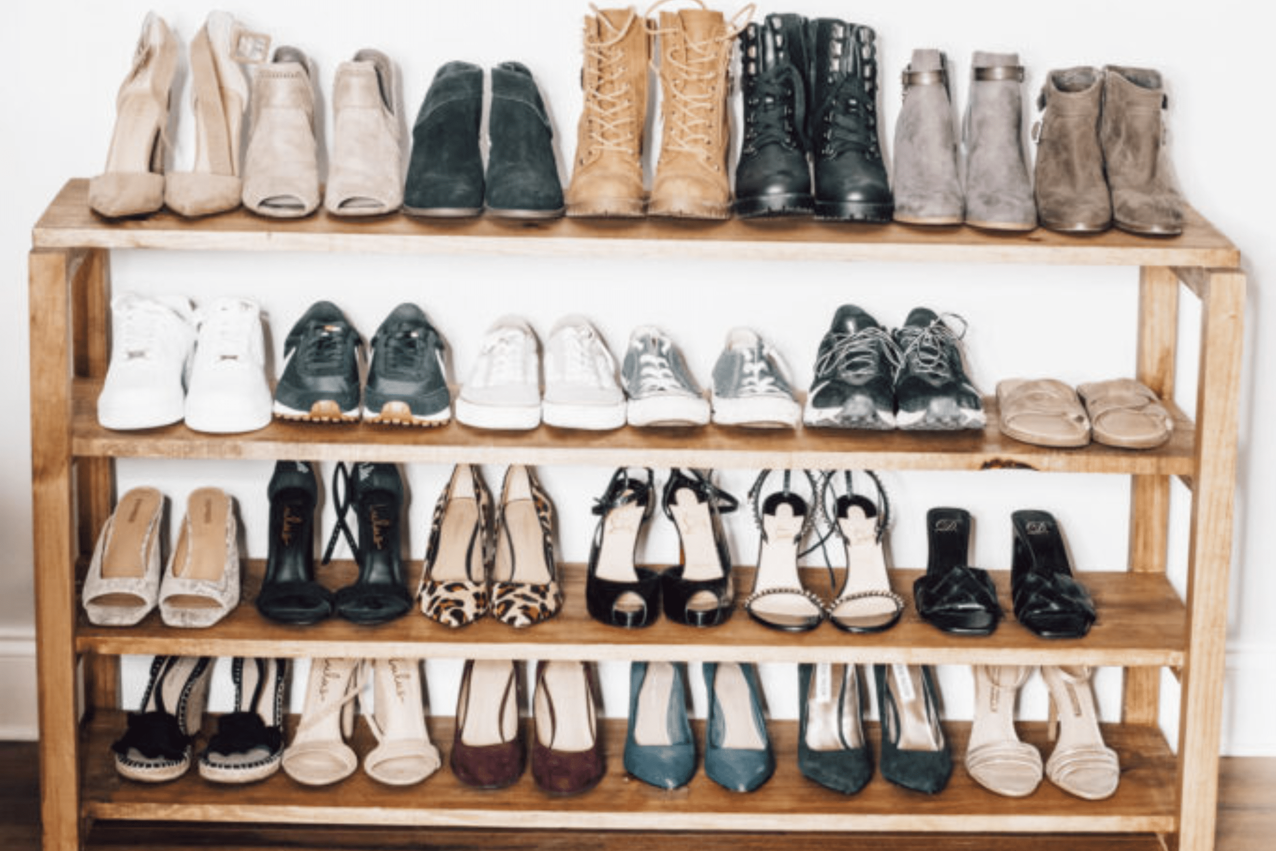 A four shelf DIY shoe rack made of wood.