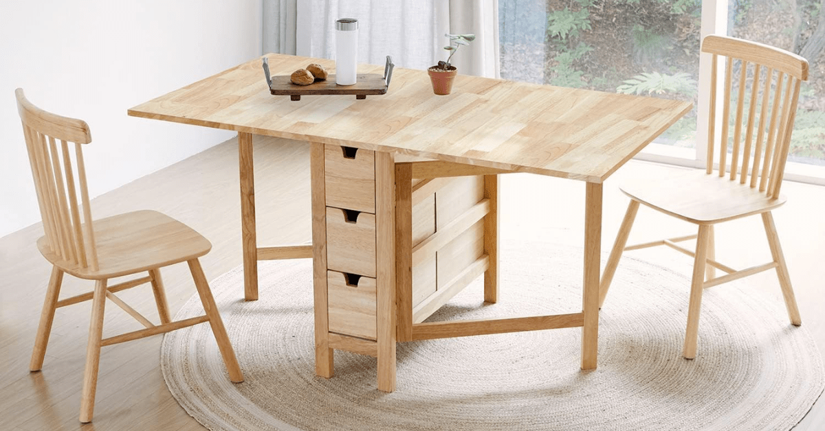 A wooden drop leaf table and chairs.