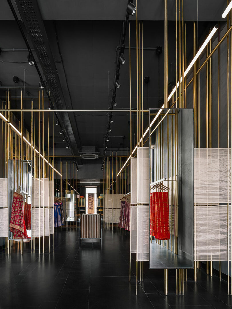 Vertical gold rods from which shelves are built and garments hang.