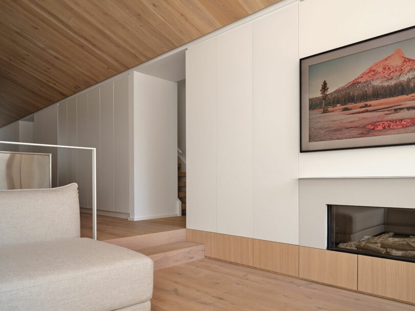 angled partial interior view of modern living space with edge of sofa looking to dining room
