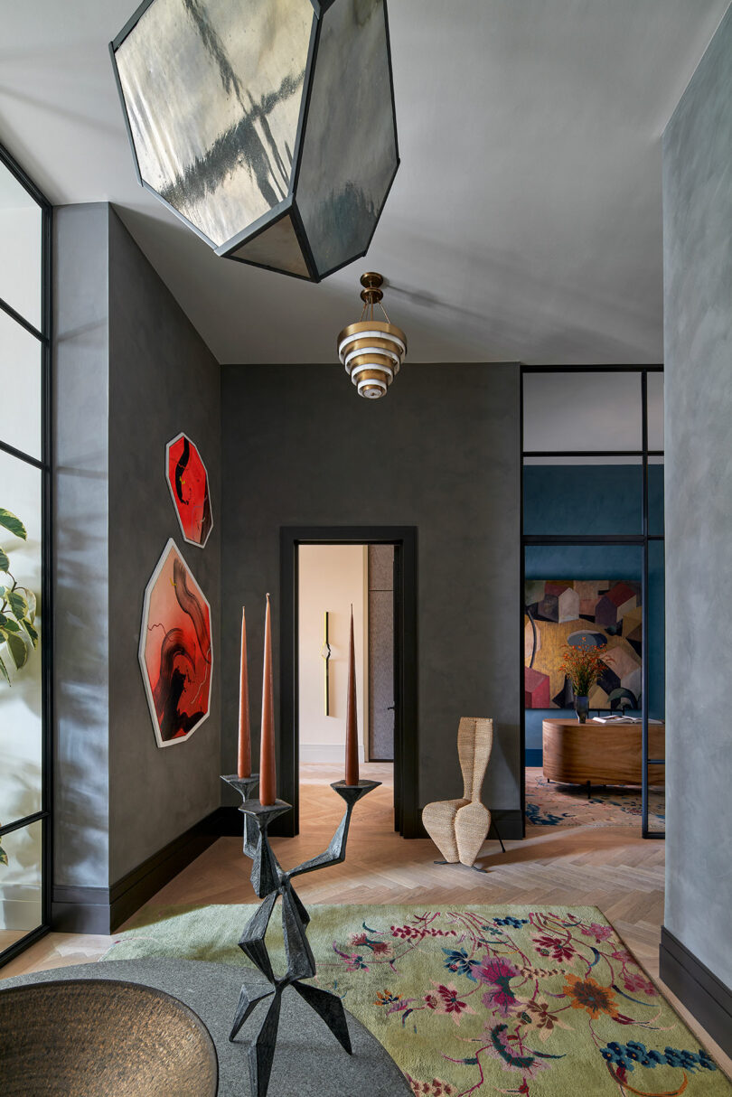 view of moody gray hallway in modern apartment with curated design pieces