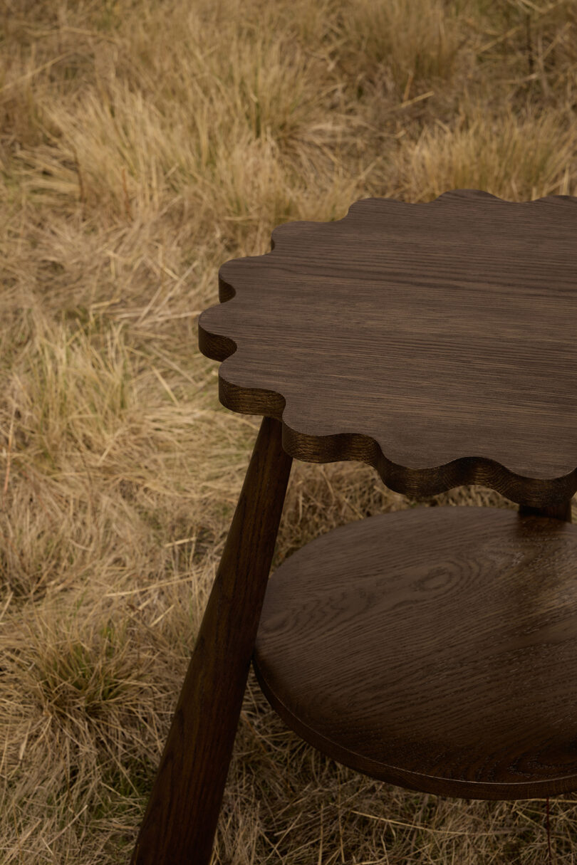 dark wood tripod stool in an off-season field