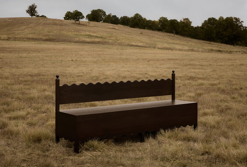 dark wood bench in an off-season field