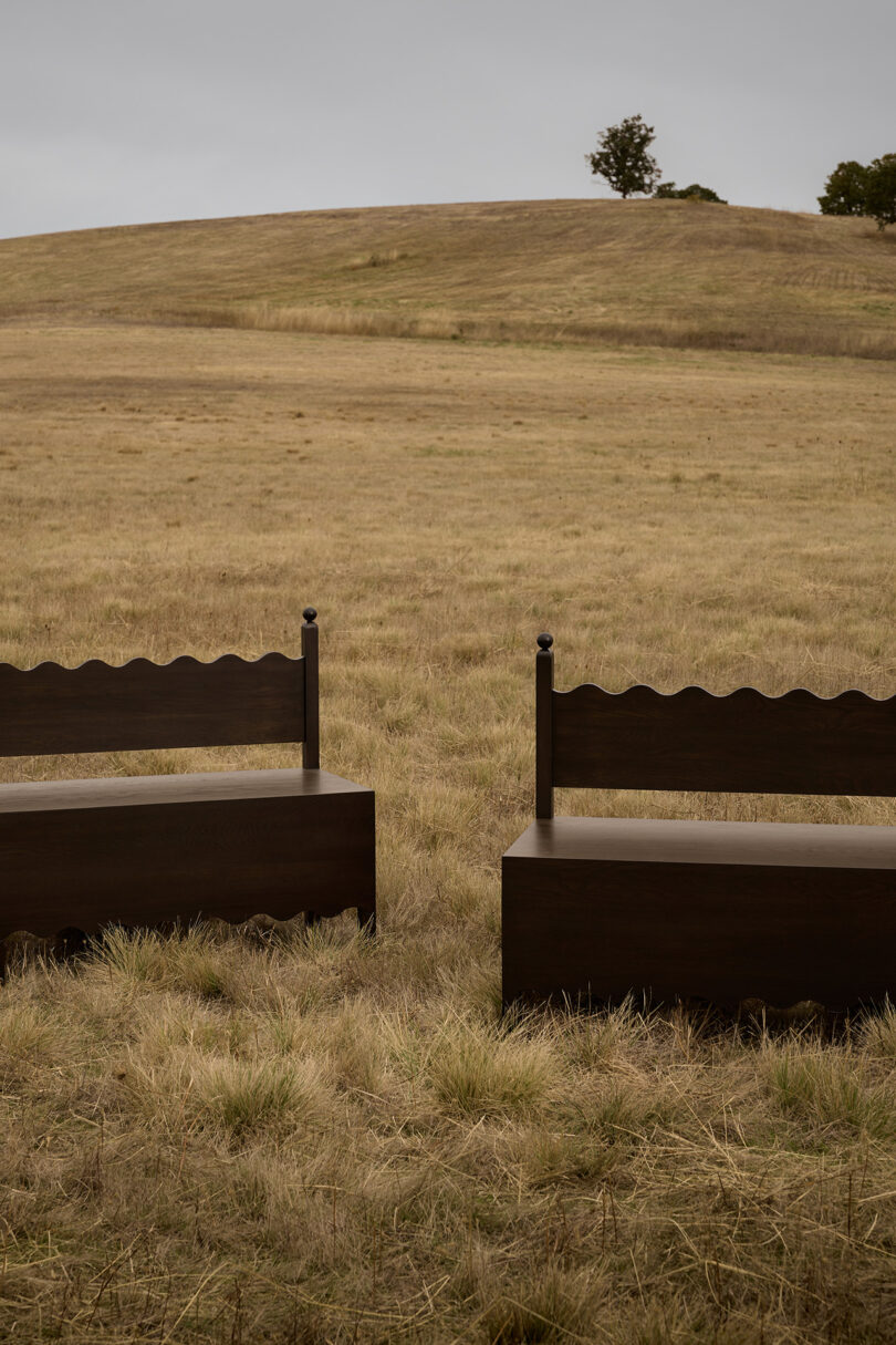 dark wood bench in an off-season field