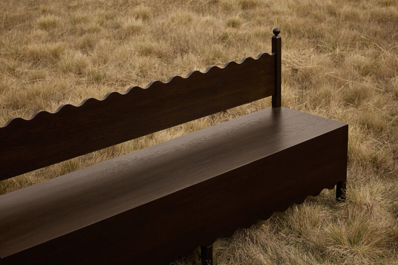 dark wood bench in an off-season field