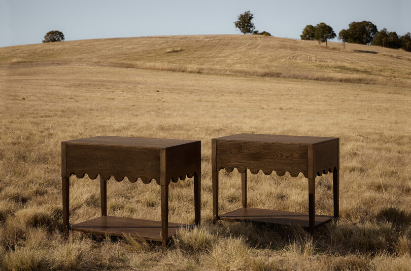 two dark wood nightstands in an off-season field