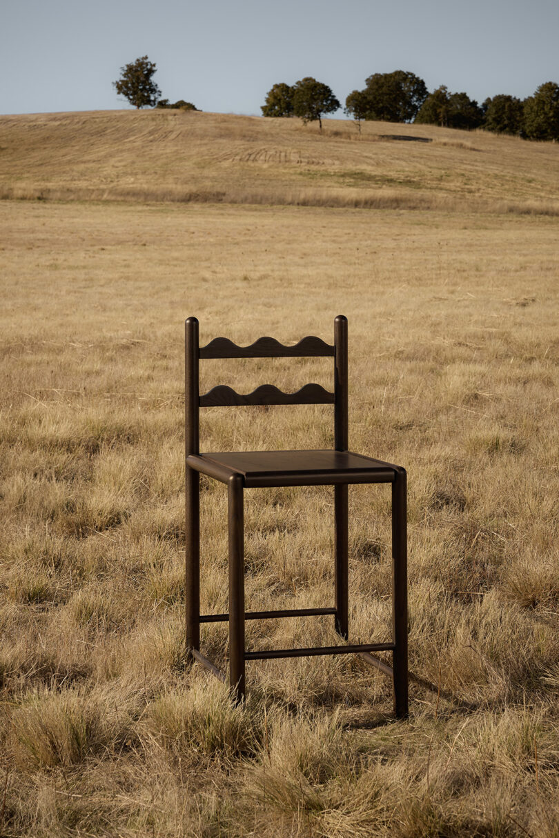 tall dark wood stool in an off-season field