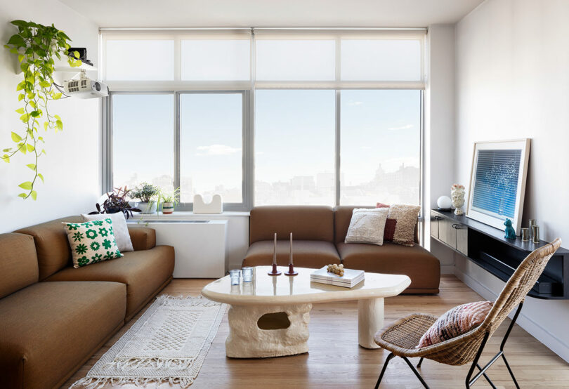 A living room space with seating on the left and straight ahead anchored by a coffee table.