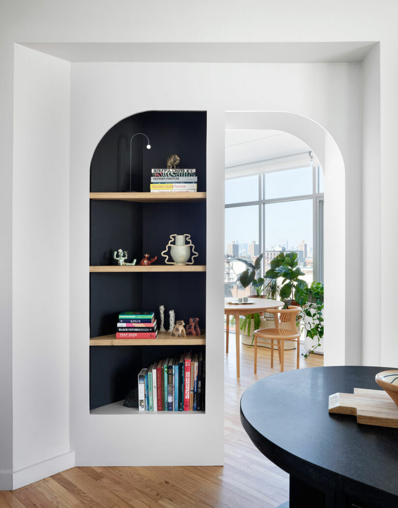 A visual archway that is half solid bookshelf and half a passageway.