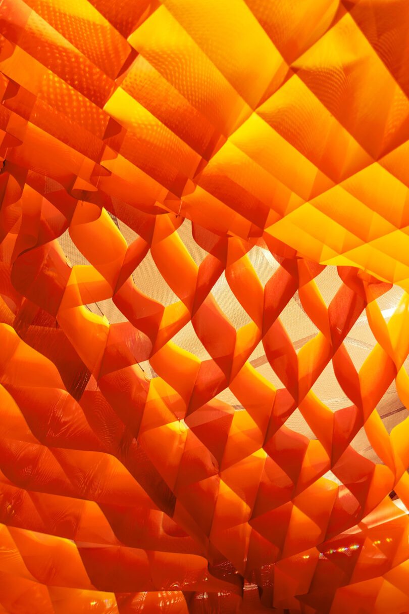 detail of orange net-like outdoor pavilion