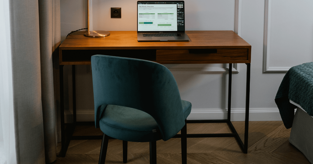 Teal chair and wooden small corner desk.